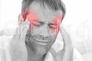 Man having a headache at home