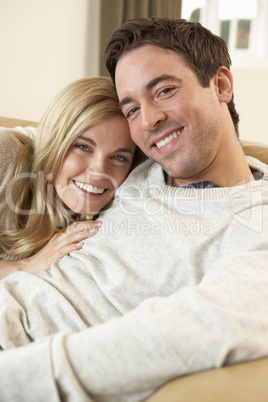 Young couple sitting and relaxing on sofa