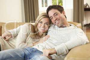 Young couple sitting and relaxing on sofa