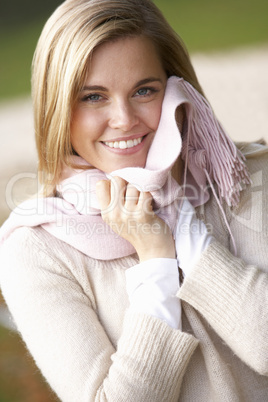 Young woman having portrait with scarf outside looking at camera
