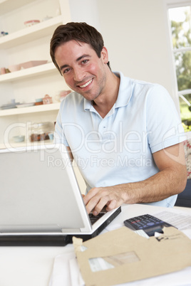 Young man working with laptop computer