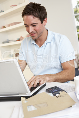 Young man working with laptop computer