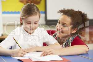 Schoolgirl Studying In Classroom With Teacher