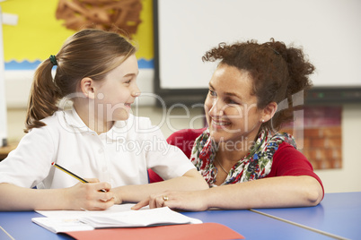 Schoolgirl Studying In Classroom With Teacher