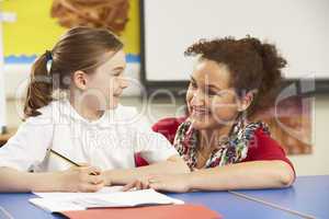 Schoolgirl Studying In Classroom With Teacher