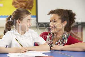 Schoolgirl Studying In Classroom With Teacher