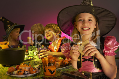 Halloween party with children having fun in fancy costumes