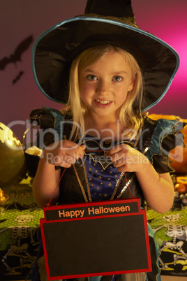 Halloween party with a child holding sign
