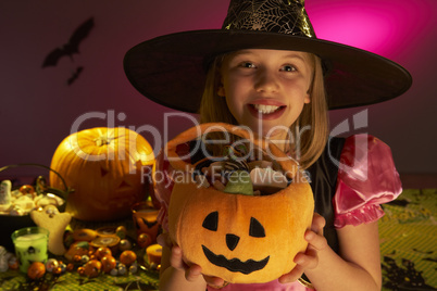 Halloween party with a child showing candy