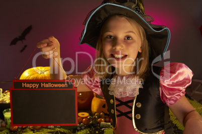 Halloween party with a child holding sign in hand