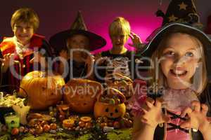 Halloween party with children wearing scaring costumes