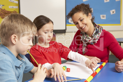 Schoolchildren Studying in classroom with teacher
