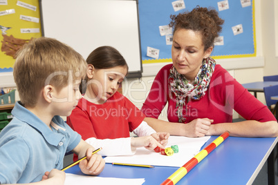 Schoolchildren Studying in classroom with teacher