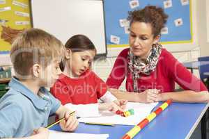 Schoolchildren Studying in classroom with teacher