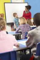 Schoolchildren Studying In Classroom With Teacher