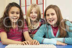 Group Of Schoolgirls In IT Class Using Computer