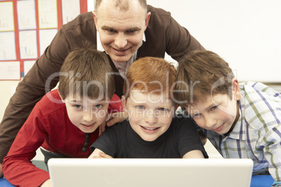 Group Of Schoolboys In IT Class Using Computer