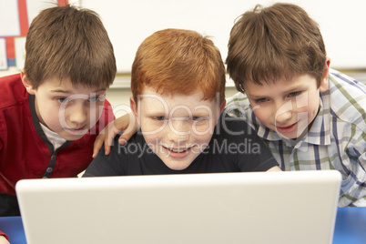 Group Of Schoolboys In IT Class Using Computer