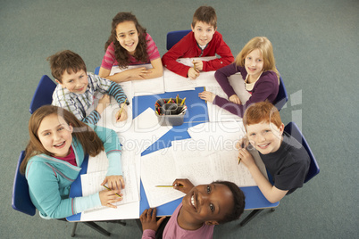 Overhead View Of Schoolchildren Working Together At Desk