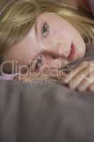 Depressed Teenage Girl Lying In Bedroom