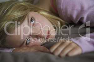 Depressed Teenage Girl Lying In Bedroom