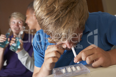 Group Of Teenage Boys Taking Drugs At Home