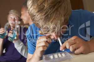 Group Of Teenage Boys Taking Drugs At Home
