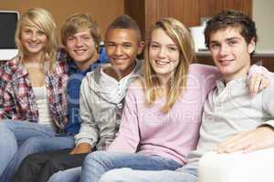 Group Of Teenage Friends Sitting On Sofa At Home
