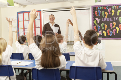 Schoolchildren Studying In Classroom With Teacher