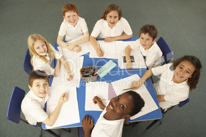 Overhead View Of Schoolchildren Working Together At Desk