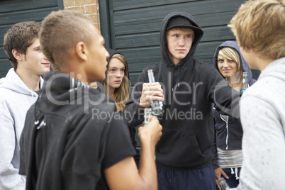 Group Of Threatening Teenagers Hanging Out Together Outside Drin