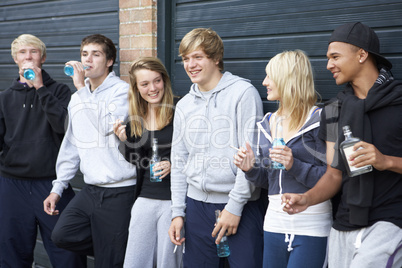 Group Of Teenagers Hanging Out Together Outside Drinking