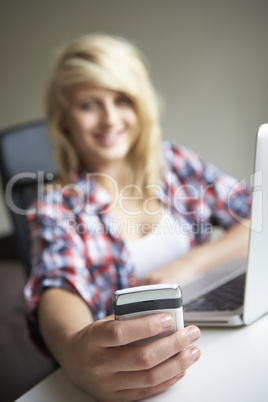 Teenage Girl Using Laptop And Mobile At Home