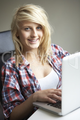 Teenage Girl Using Laptop At Home