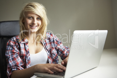 Teenage Girl Using Laptop At Home
