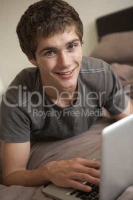 Teenage Boy Using Laptop At Home