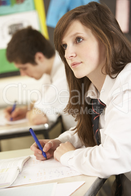 Female Teenage Student Studying In Classroom