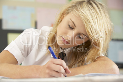 Female Teenage Student Studying In Classroom