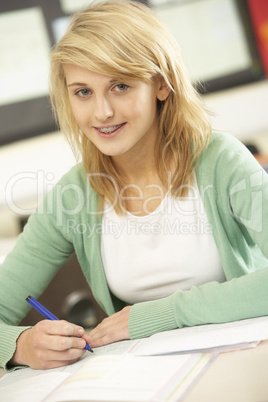 Female Teenage Student Studying In Classroom