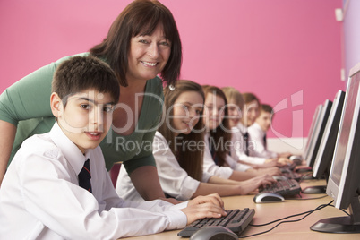 Teenage Students In IT Class Using Computers In Classroom With T