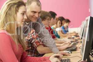 Teenage Students In IT Class Using Computers In Classroom With T