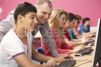 Teenage Students In IT Class Using Computers In Classroom With T