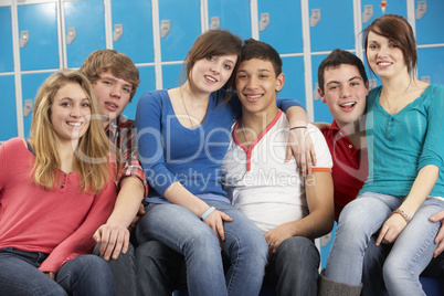 Teenage Students Relaxing By Lockers In School