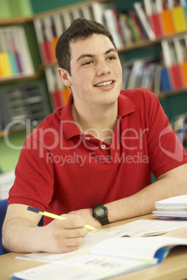 Teenage Male Student In Working In Classroom