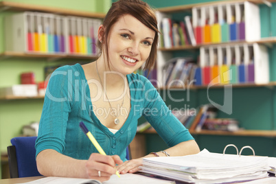 Teenage Female Student In Working In Classroom