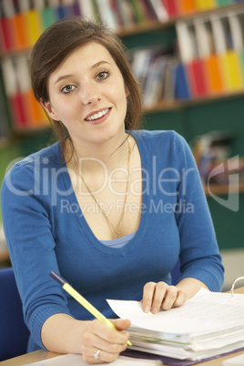 Teenage Female Student In Working In Classroom