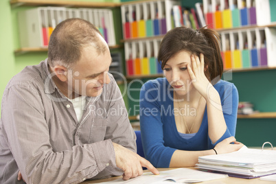 Teenage Student In Classroom With Tutor