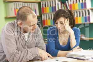 Teenage Student In Classroom With Tutor