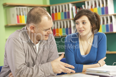 Teenage Student In Classroom With Tutor