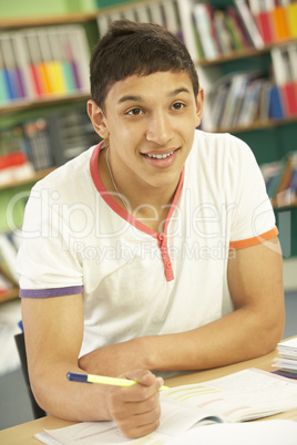 Teenage Male Student In Working In Classroom